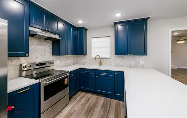 a kitchen with wooden cabinets and a stove top oven