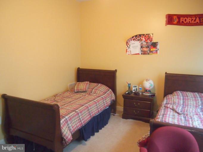 14407 Bubbling Spring Road Boyds, MD 20841 - Photo 7 of 30 a bedroom with a bed and a couch