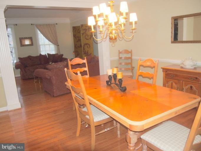 14407 Bubbling Spring Road Boyds, MD 20841 - Photo 8 of 30 a dining room with furniture and chandelier or wooden floor