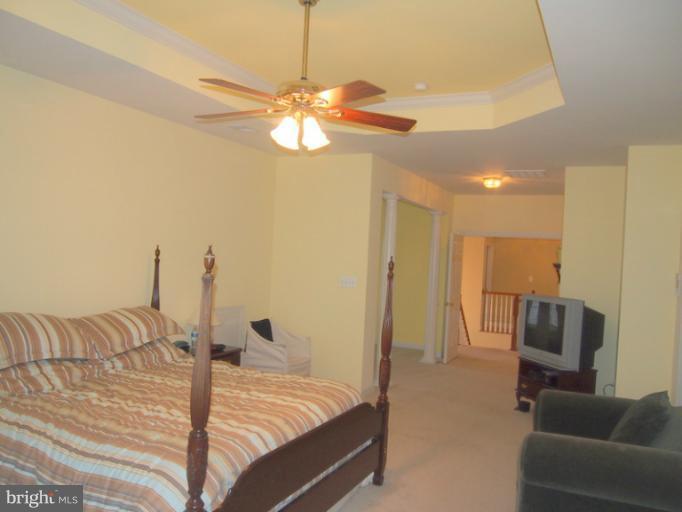 14407 Bubbling Spring Road Boyds, MD 20841 - Photo 10 of 30 a bedroom with a bed and ceiling fan