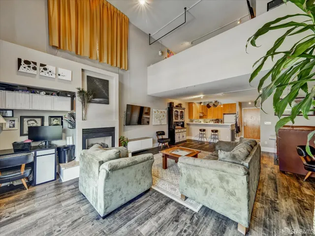 a living room with furniture a fireplace and a potted plant
