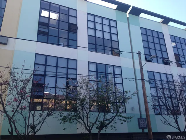 a view of a brick building next to a yard