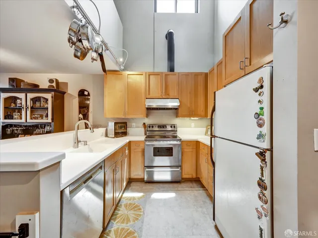 a kitchen with stainless steel appliances a refrigerator sink and cabinets