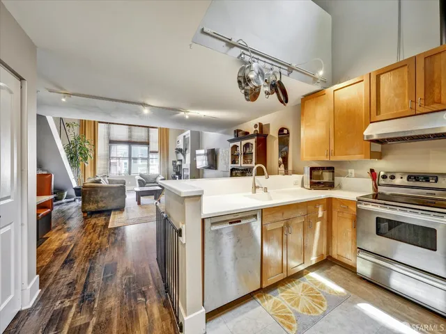 a open kitchen with stainless steel appliances granite countertop a stove and cabinets