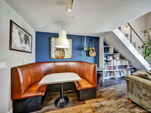a living room with furniture and a book shelf