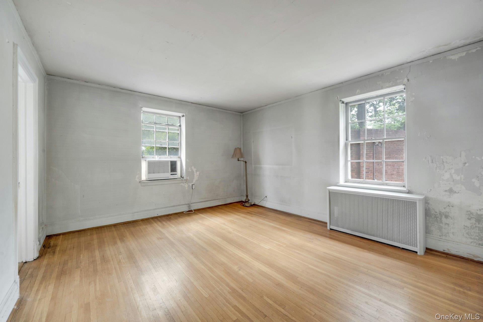 3 Alden Place, Unit 1A Bronxville, NY 10708 - Photo 18 of 29 an empty room with wooden floor and windows