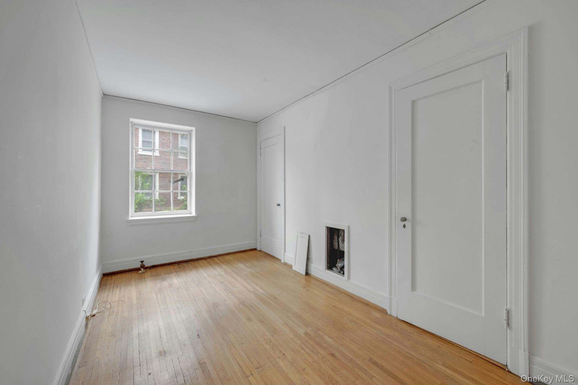 3 Alden Place, Unit 1A Bronxville, NY 10708 - Photo 22 of 29 an empty room with wooden floor and windows