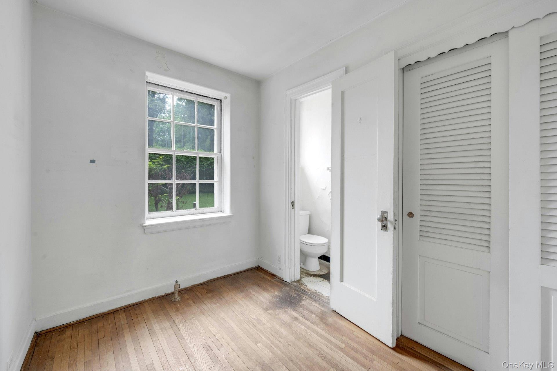 3 Alden Place, Unit 1A Bronxville, NY 10708 - Photo 25 of 29 an empty room with wooden floor and windows