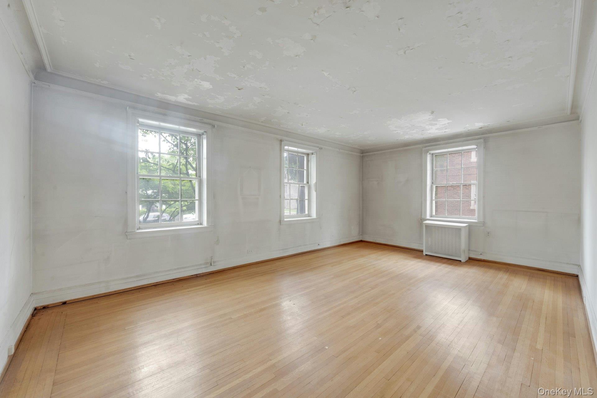 3 Alden Place, Unit 1A Bronxville, NY 10708 - Photo 4 of 29 a view of an empty room with wooden floor and a window
