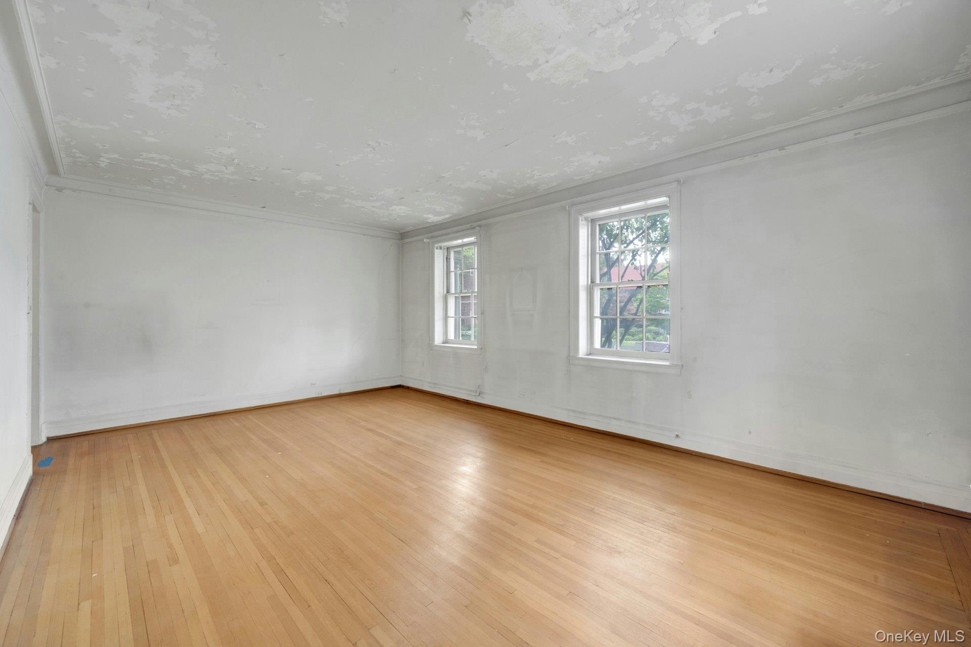 3 Alden Place, Unit 1A Bronxville, NY 10708 - Photo 7 of 29 a view of an empty room with wooden floor and a window