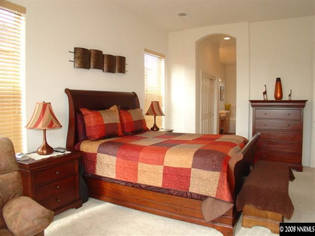 1660 Silver Thread Drive Reno, NV 89521 - Photo 4 of 9 a bedroom with a bed and a night stand
