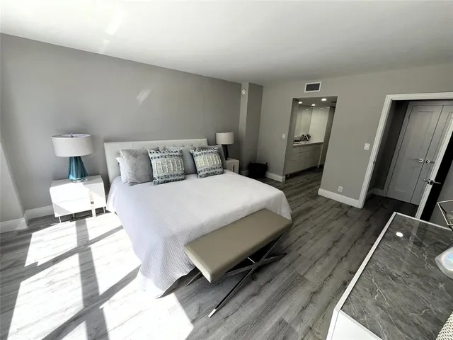 a large white kitchen with a large window