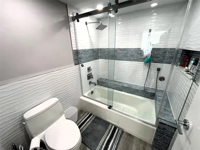 a bedroom with a bed and a mirror