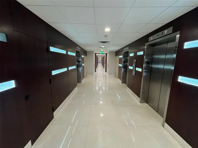 a view of a house with a yard and potted plants