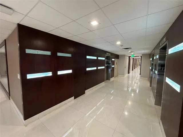 a front view of a house with a tree