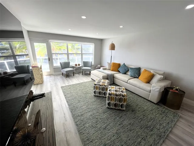 a kitchen with a sink cabinets and wooden floor