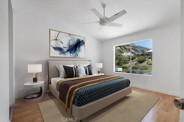 a bedroom with a bed and a painting on the wall