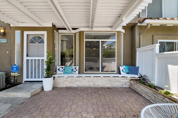 a swimming pool with outdoor seating and a yard