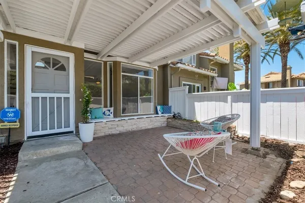 a backyard of a house with table and chairs