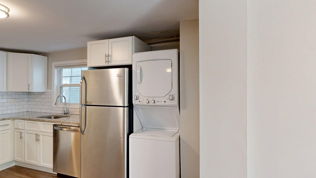 187 Maverick Street, Unit 3 Boston, MA 02128 - Photo 4 of 11 a white refrigerator freezer and a stove sitting inside of a kitchen