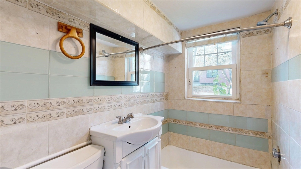 187 Maverick Street, Unit 3 Boston, MA 02128 - Photo 5 of 11 a bathroom with a sink and a mirror