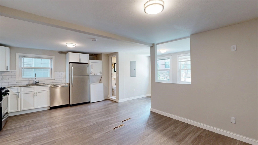 187 Maverick Street, Unit 3 Boston, MA 02128 - Photo 6 of 11 a kitchen with a refrigerator and a stove top oven