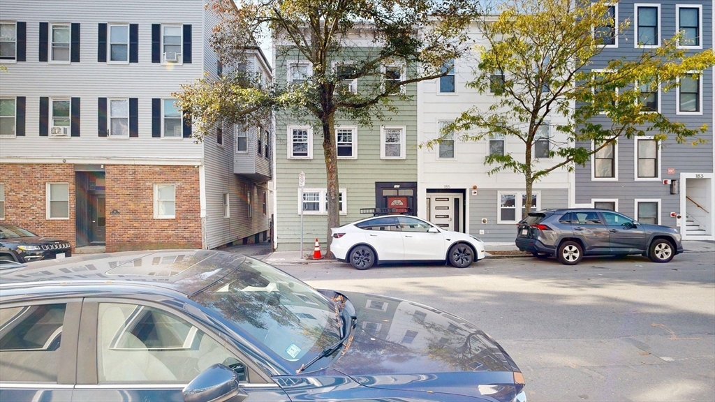 187 Maverick Street, Unit 3 Boston, MA 02128 - Photo 9 of 11 a view of a cars park in front of a building
