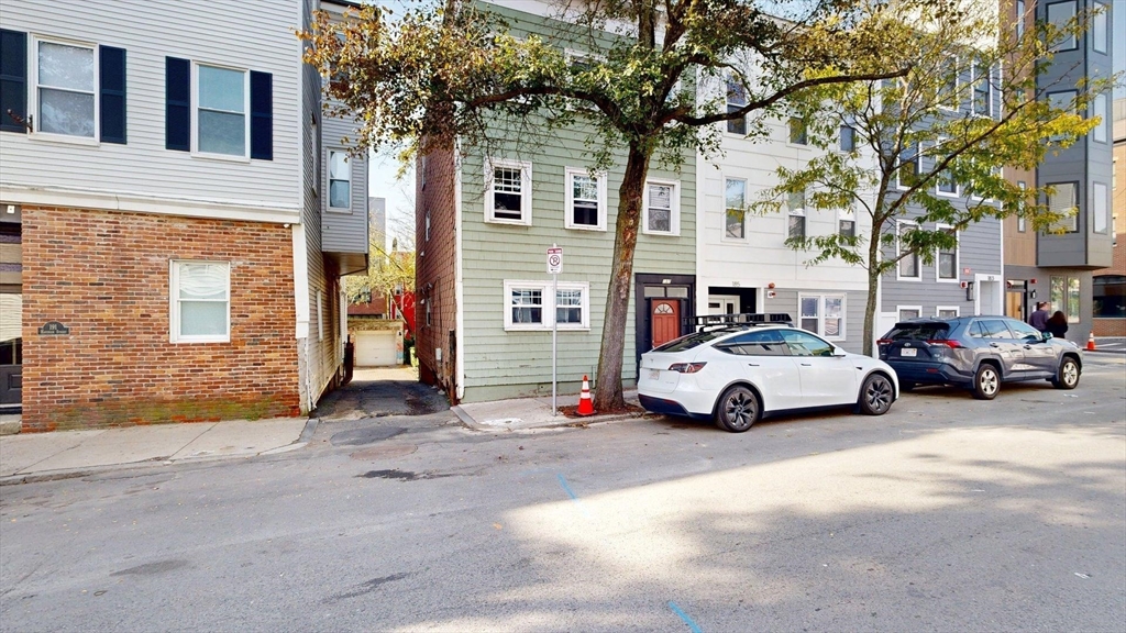 187 Maverick Street, Unit 3 Boston, MA 02128 - Photo 10 of 11 a view of street with parked cars