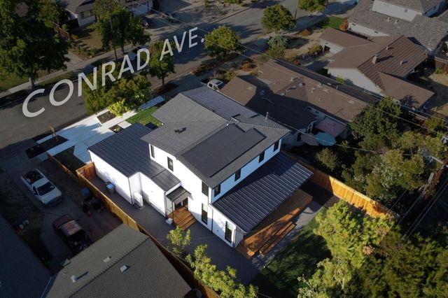 an aerial view of a house with a yard