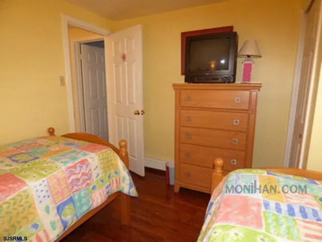 a bedroom with a bed and flat screen tv