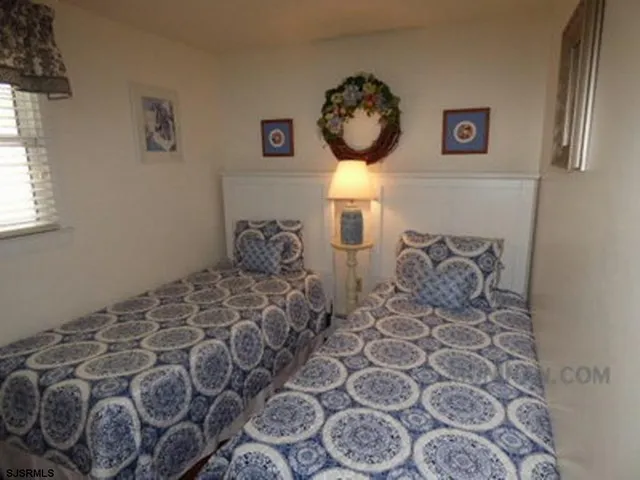 a large bed sitting in a bedroom next to a window