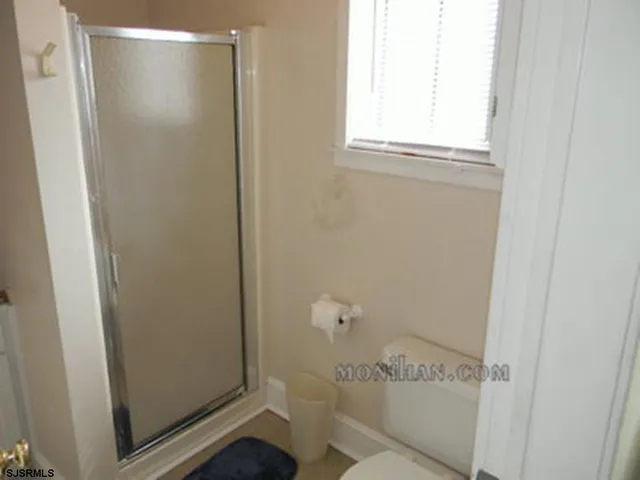 a front view of a house with wooden fence