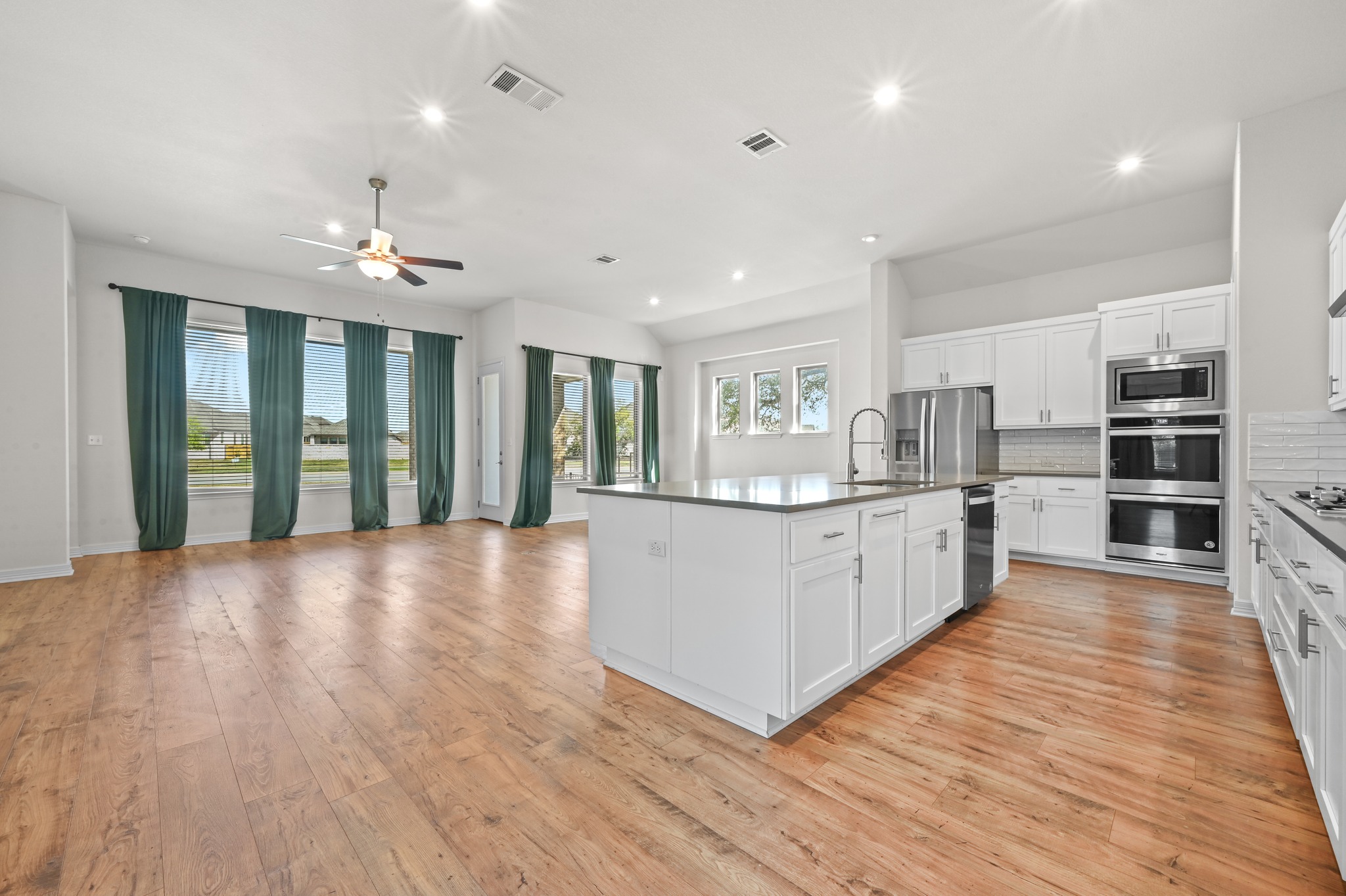 208 West Branch Road Kyle, TX 78640 - Photo 6 of 27 The kitchen, dining, and living areas all come together in one central space that feels connected without feeling crowded.