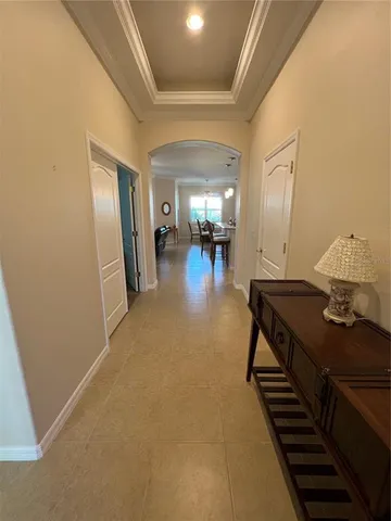 a living room with stainless steel appliances kitchen island granite countertop a stove a sink a dining table and chairs with wooden floor