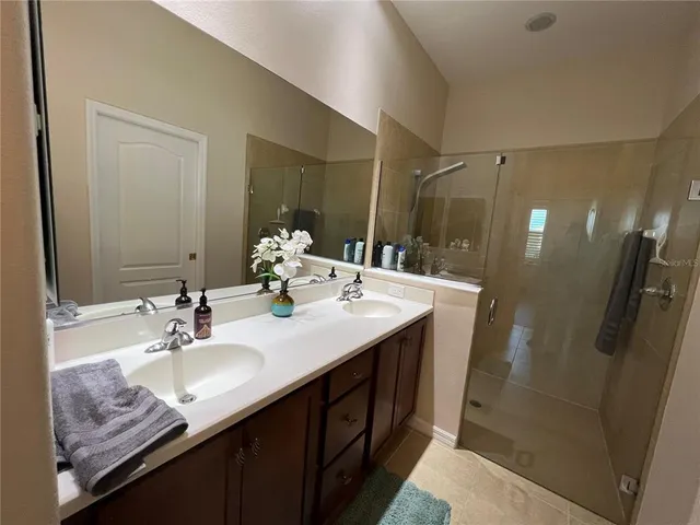 a bedroom with two beds and a flat screen tv