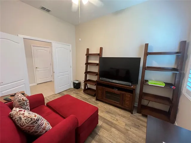 a view of a chair and table in backyard of the house