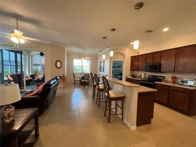 a large kitchen with kitchen island a sink a counter space and stainless steel appliances