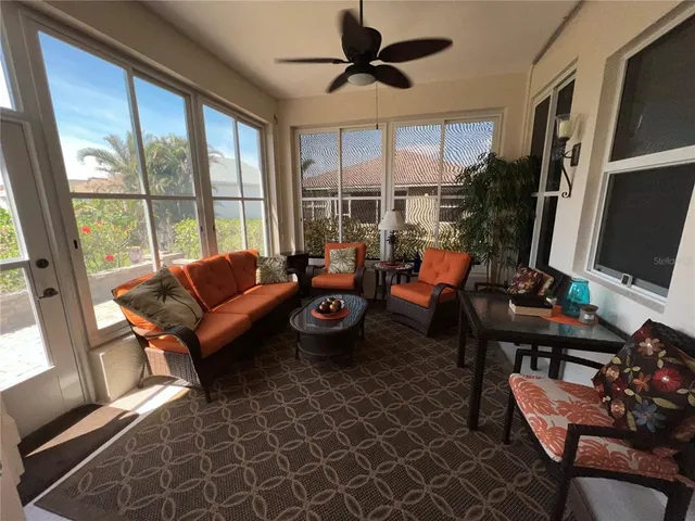 a room with pool table and windows