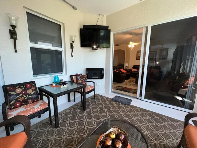 swimming pool view with a seating space and a garden view