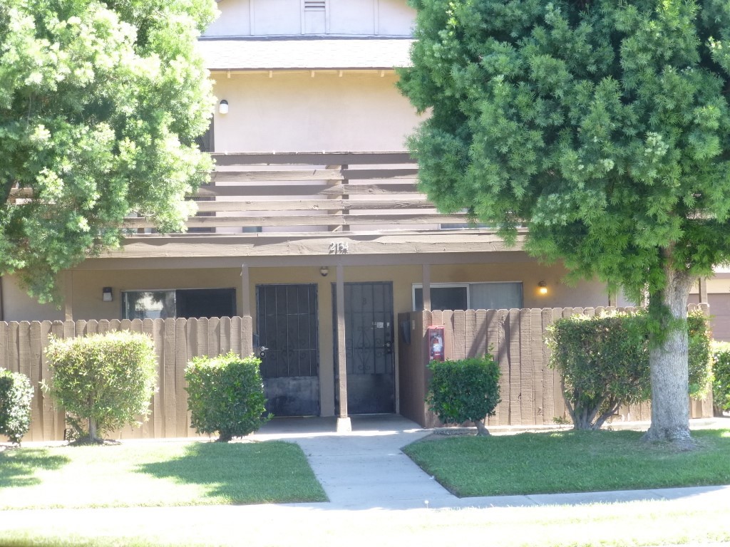 2134 South Acama Street Anaheim, CA 92802 - Photo 15 of 38 a view of a white house with a big yard and large tree