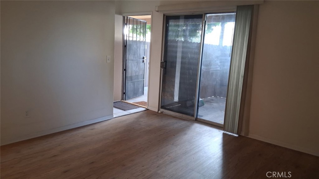 2134 South Acama Street Anaheim, CA 92802 - Photo 27 of 38 an empty room with wooden floor and windows