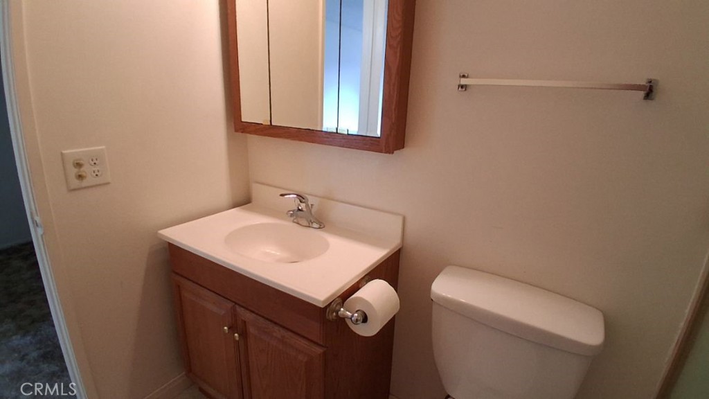 2134 South Acama Street Anaheim, CA 92802 - Photo 30 of 38 a bathroom with a toilet sink and mirror