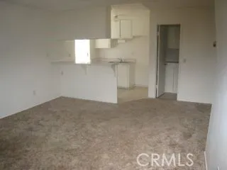 a view of an empty room and staircase