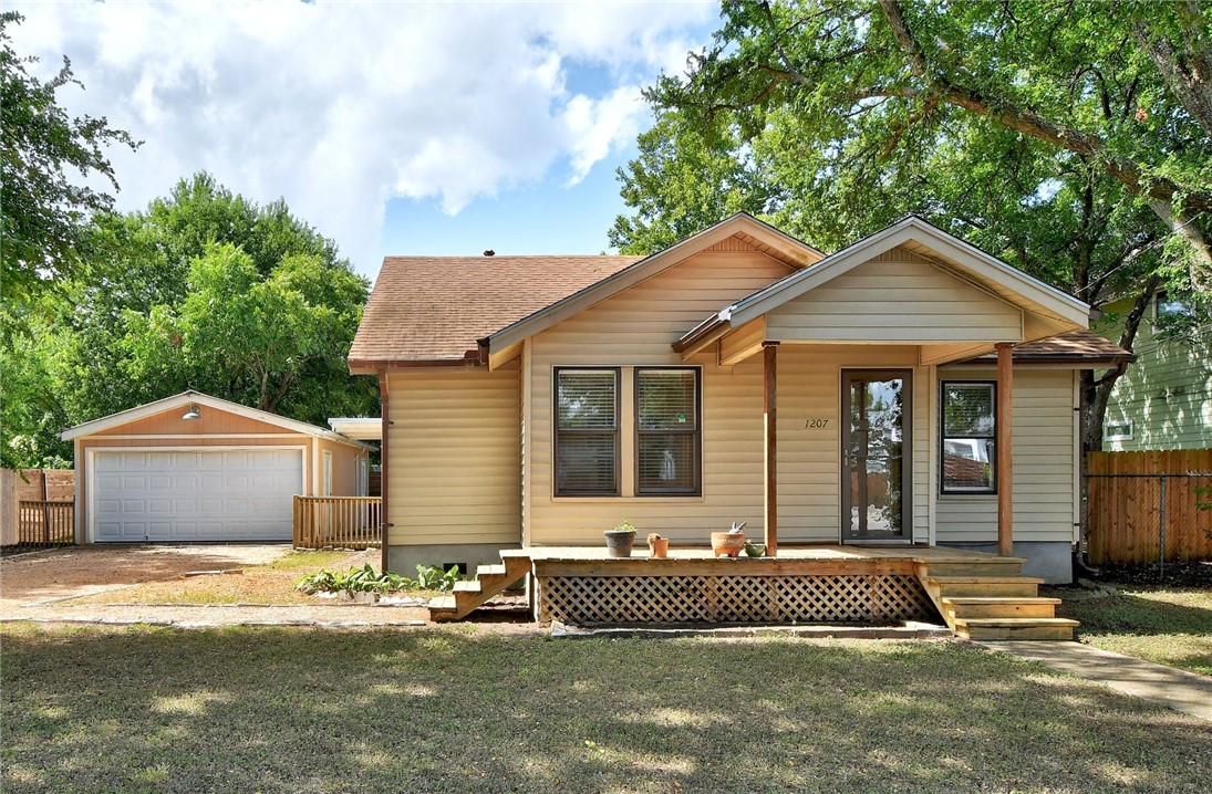 1207 Casey Street Austin, TX 78745 - Photo 1 of 1 a front view of a house with a garden and plants