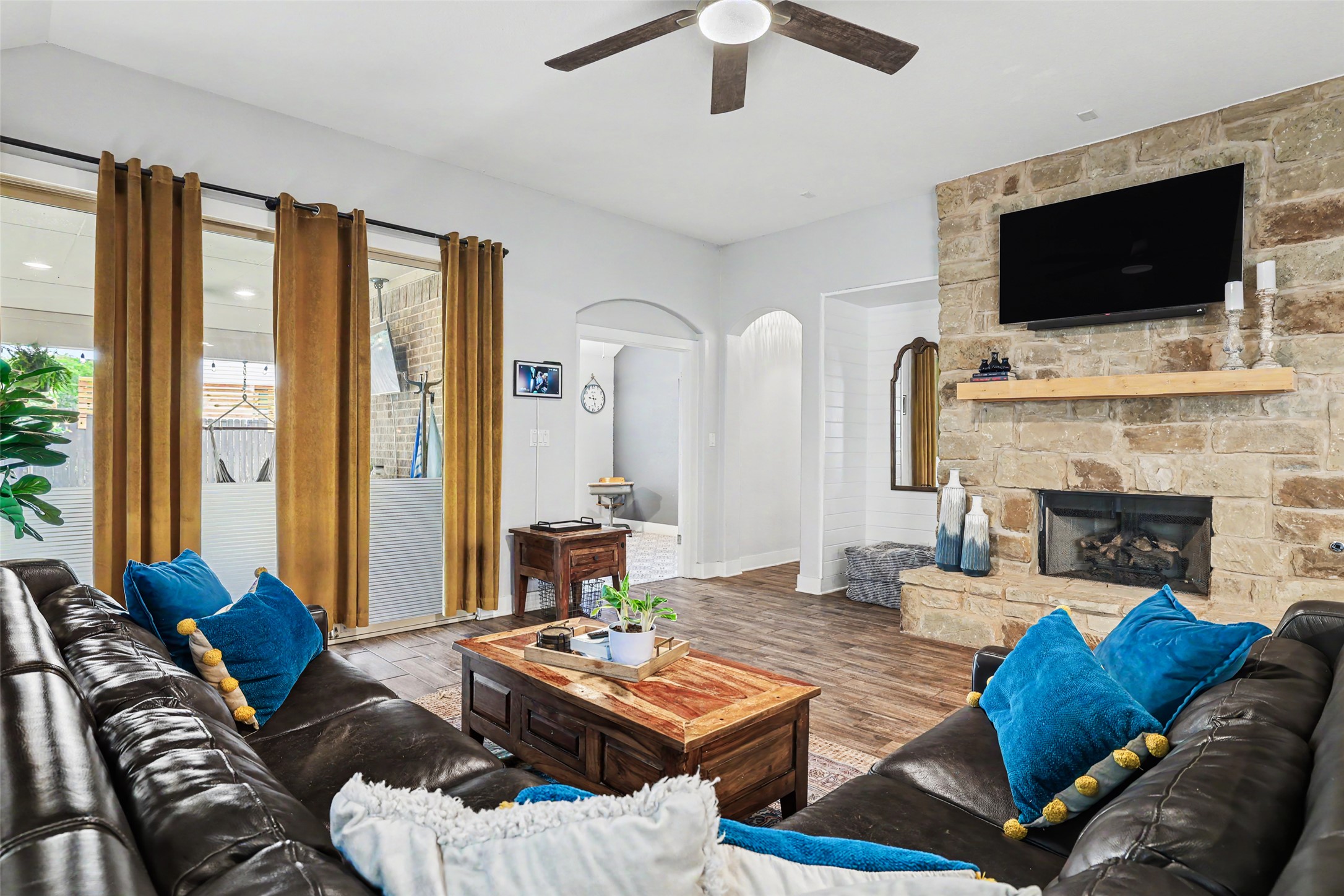 117 Rock Dock Road Georgetown, TX 78633 - Photo 20 of 38 a living room with furniture a flat screen tv and a fireplace