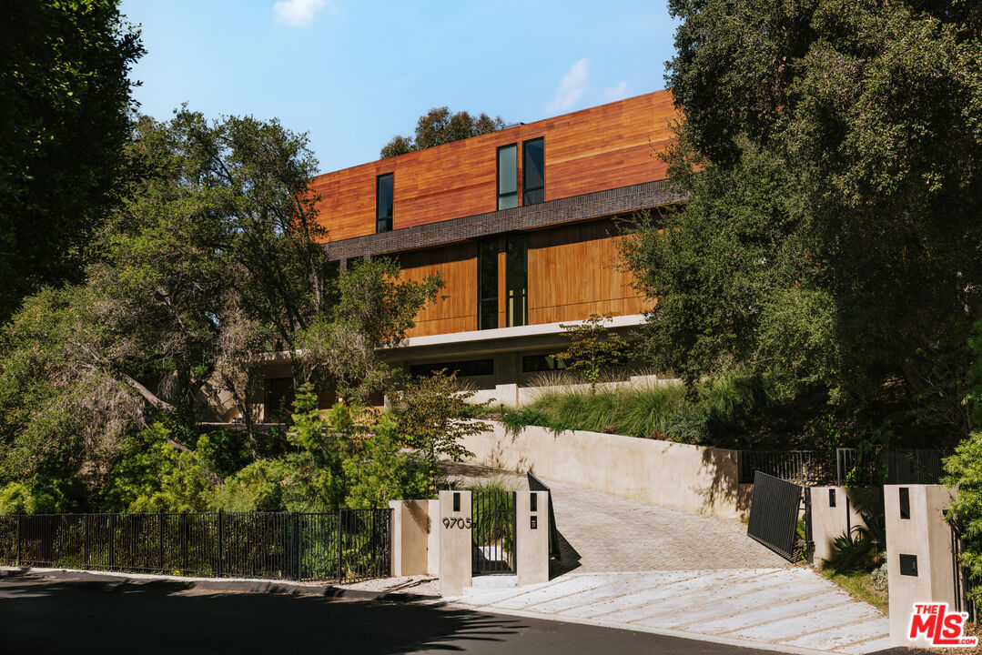 9705 Oak Pass Road Beverly Hills, CA 90210 - Photo 2 of 22 a view of a building with a yard