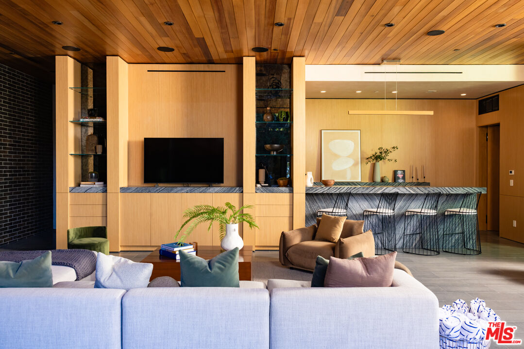 9705 Oak Pass Road Beverly Hills, CA 90210 - Photo 5 of 22 a living room with furniture and a flat screen tv