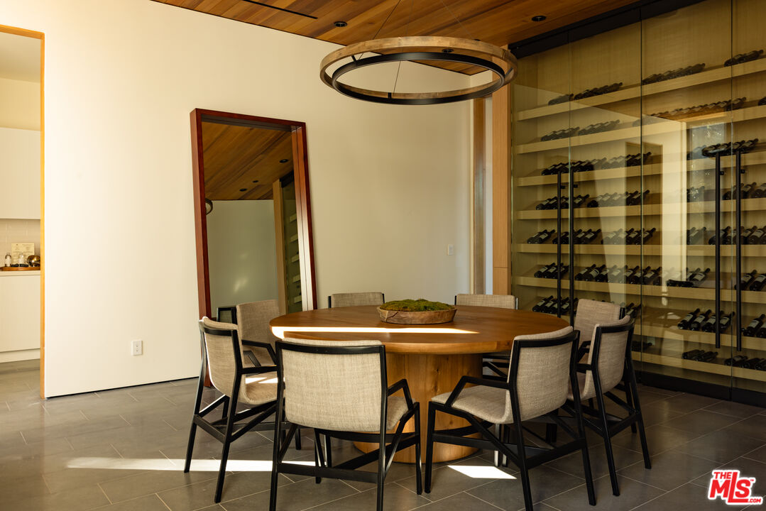 9705 Oak Pass Road Beverly Hills, CA 90210 - Photo 9 of 22 a dining room with a table and chairs