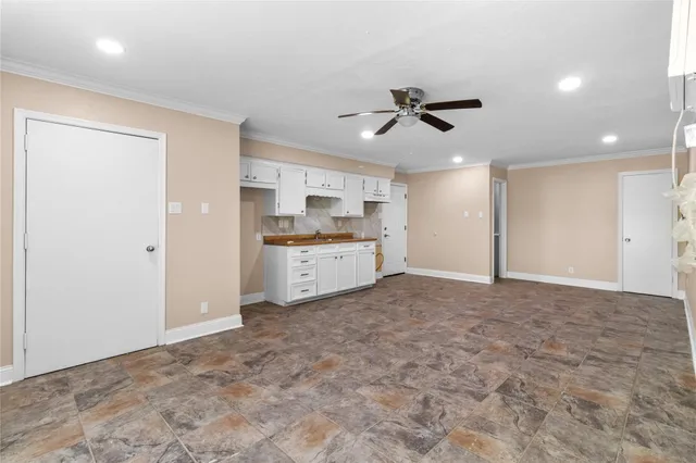 a view of a kitchen with a sink and cabinets