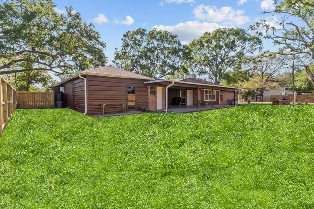 a view of a house with a yard and sitting area